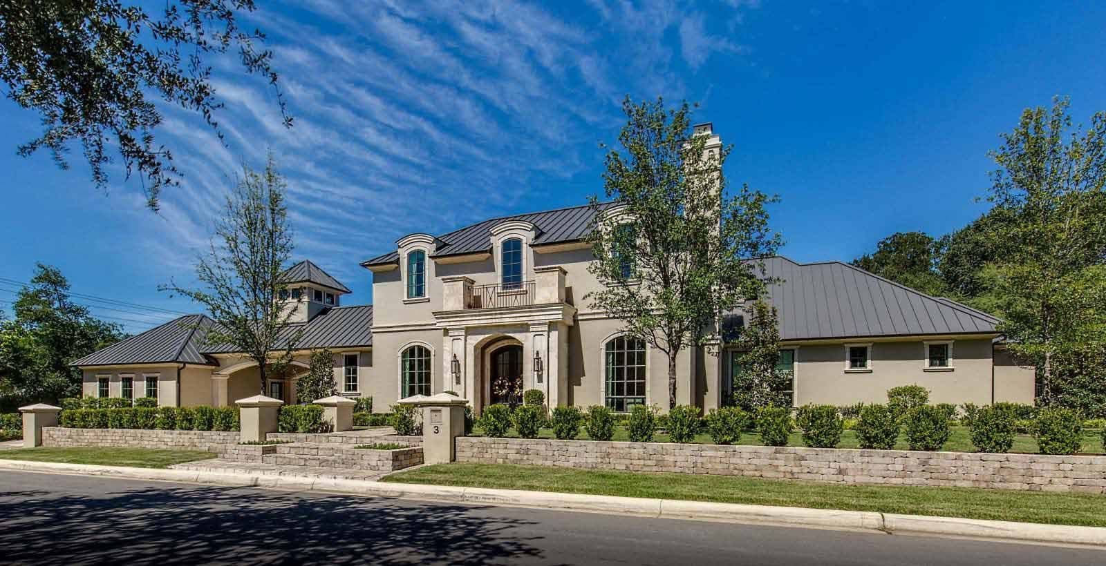 Large two-story stone home with arched windows