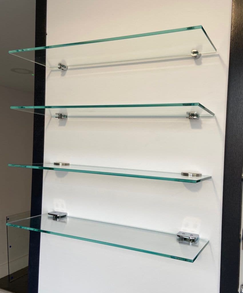 Wall-mounted glass shelves with chrome clips